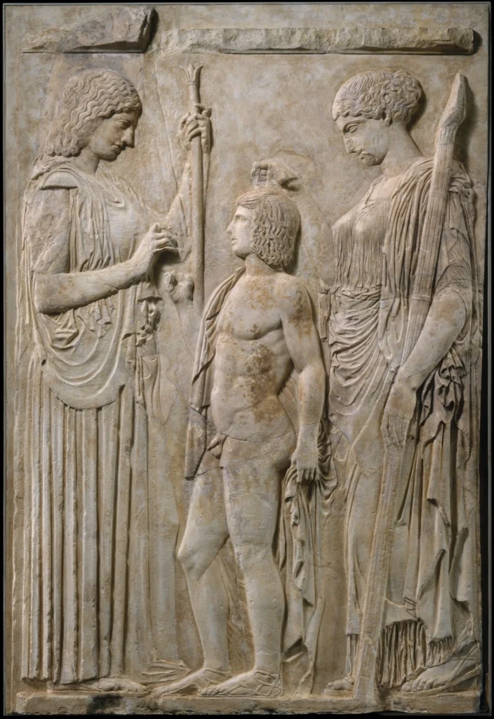 Marble relief with Demeter and Persephone standing on either side of the youthful Triptolemos.